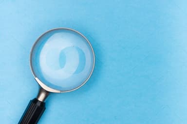 Laptop and magnifying glass representing the best patent search engines and tools