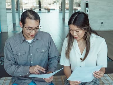 Two colleagues comparing documents, illustrating Google Patents vs professional patent search
