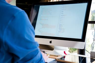 Code on a laptop screen representing a patent search API for AI agents