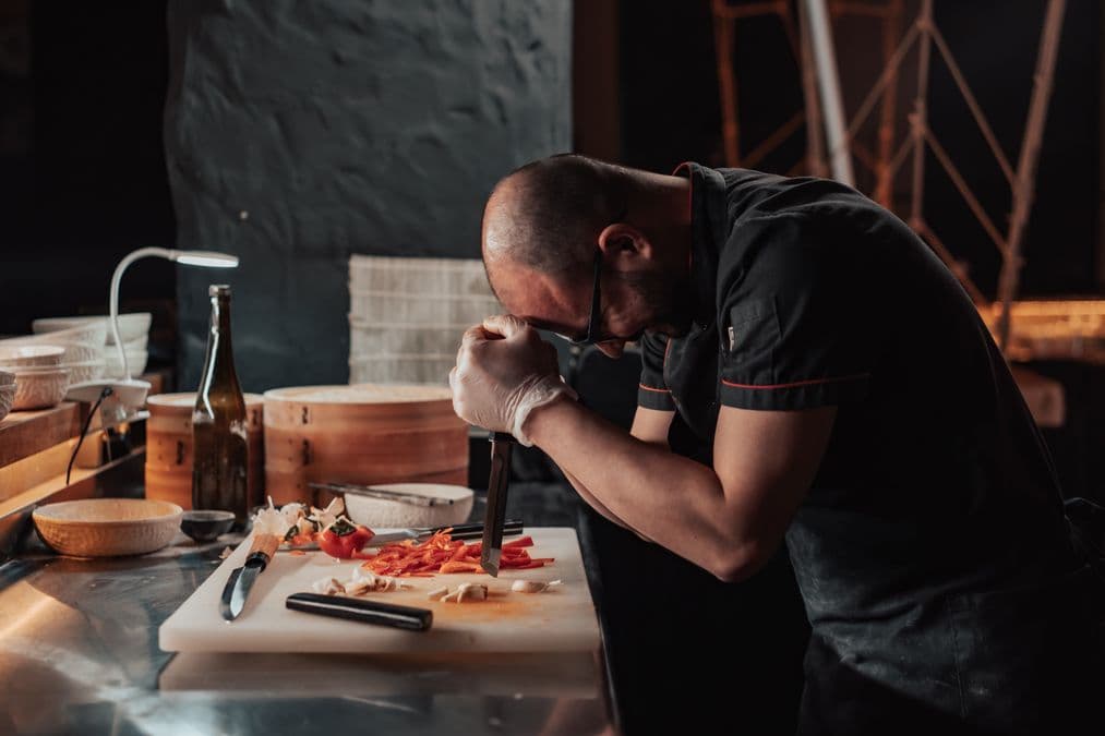 Chef cooking in a kitchen, illustrating whether you can patent a recipe
