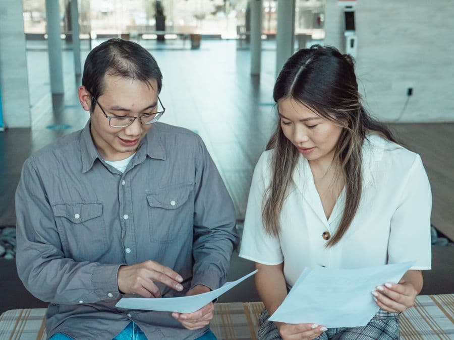 Two colleagues comparing documents, illustrating Google Patents vs professional patent search