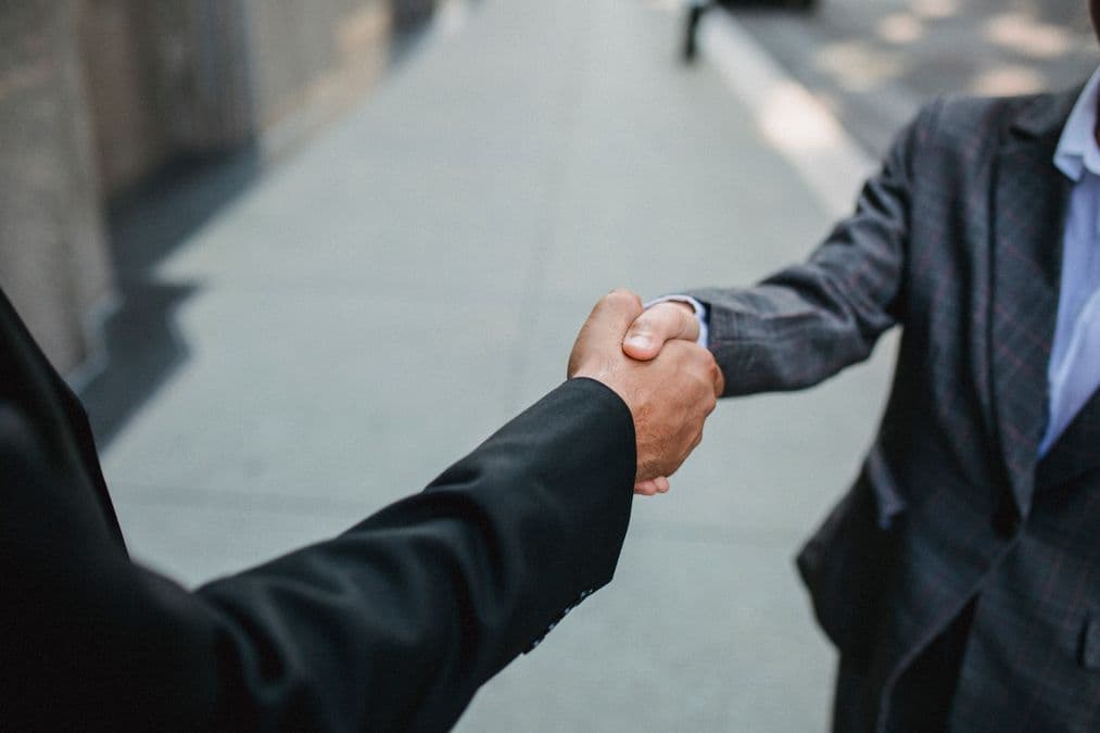 Business handshake representing a deal to sell an invention or license a patent