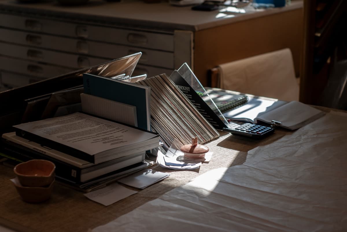 Calculator and paperwork used to work out patent search cost