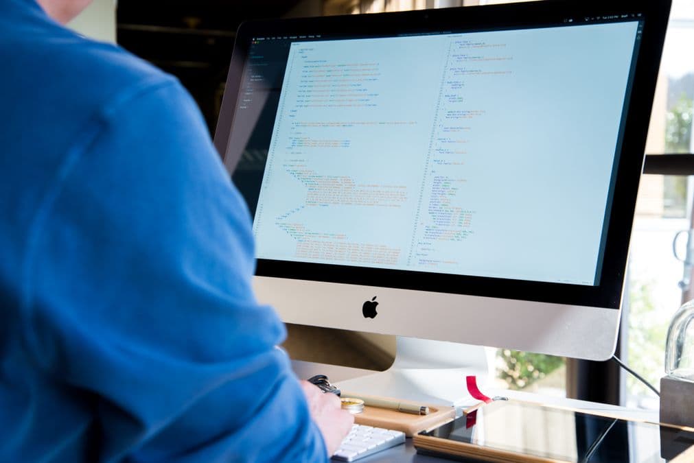 Code on a laptop screen representing a patent search API for AI agents