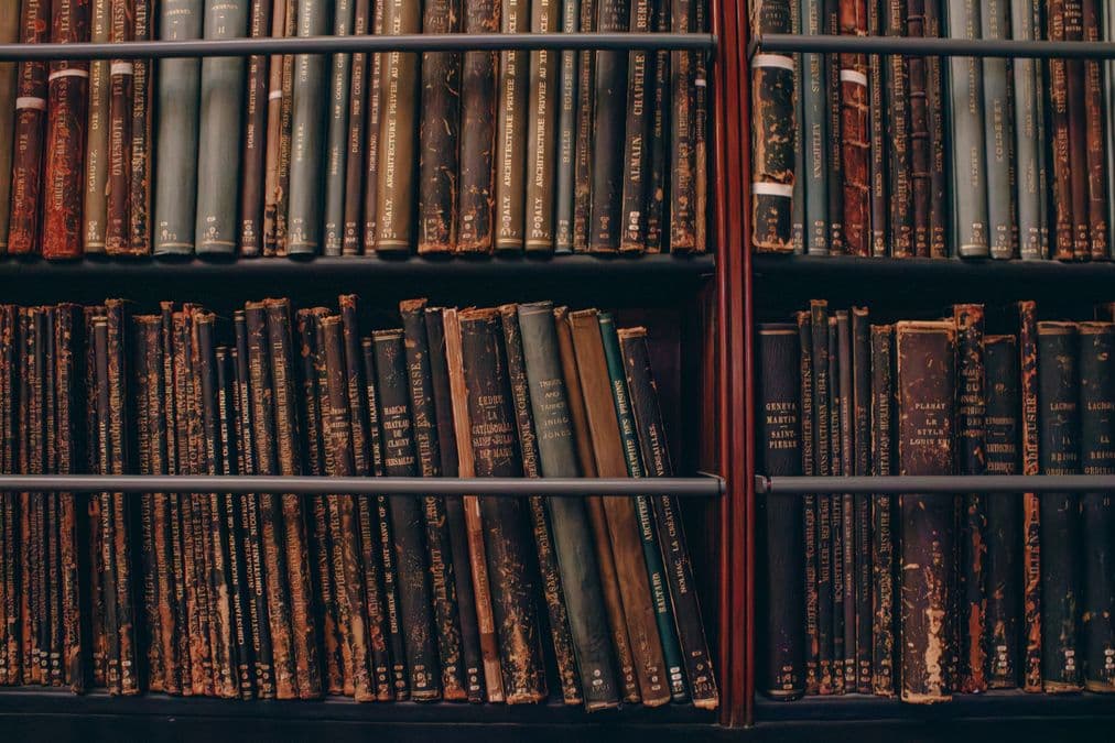 Rows of archived books representing the prior art record searched during a prior art search